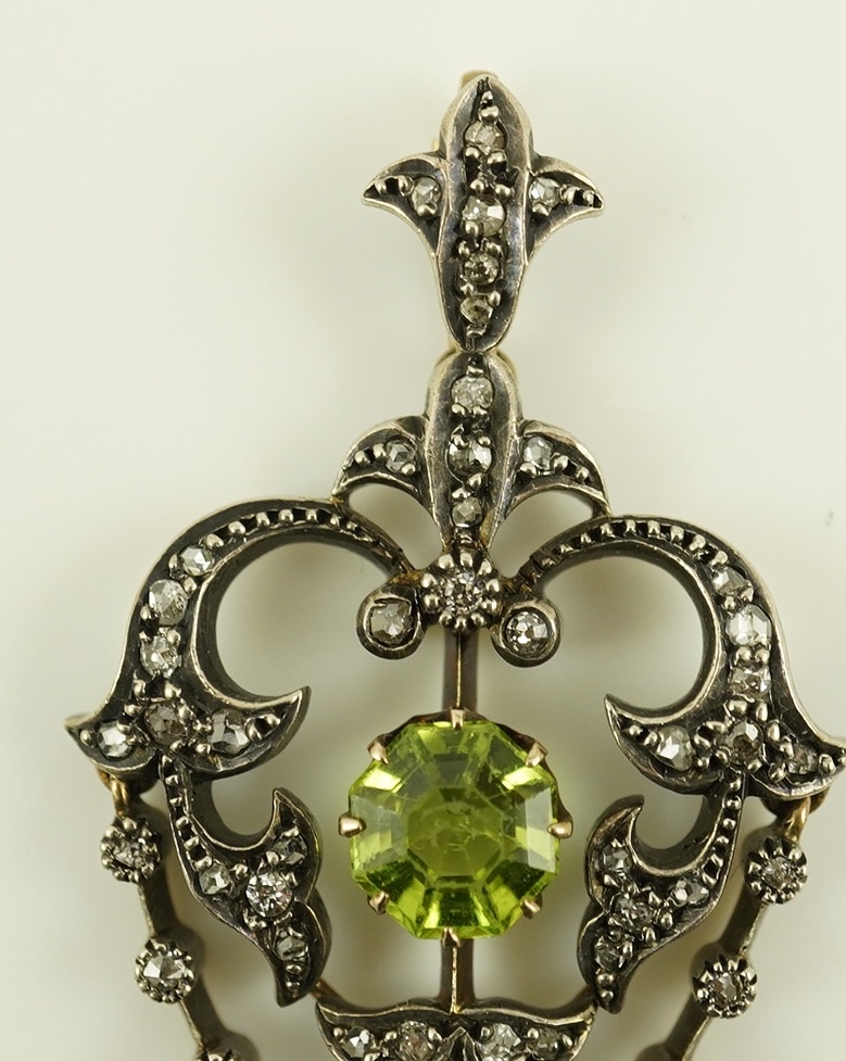 A Victorian gold and silver, peridot and diamond cluster set articulated drop pendant